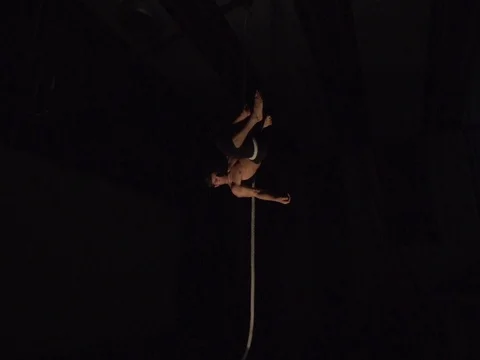 Man Doing Rope Drop Circus Trick Spotlight Performance Stock Footage 80164532