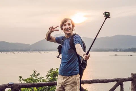 Man doing selfie on sunset background Stock Photos