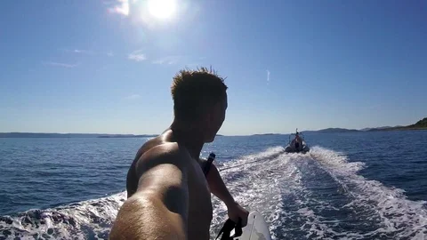 A man doing selfie while waterskiing on surfboard Stock Footage 115822967