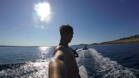 A man doing selfie while waterskiing on surfboard Stock Footage 115823006