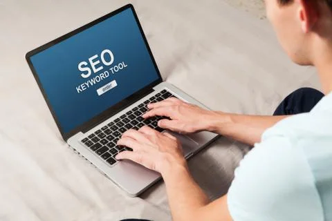Man doing a SEO positioning in a website with a laptop computer. Stock Photos