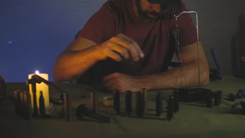 A man doing shotgun cartridges reloading with gun primers, shells, gunpowder Stock Footage 201297361