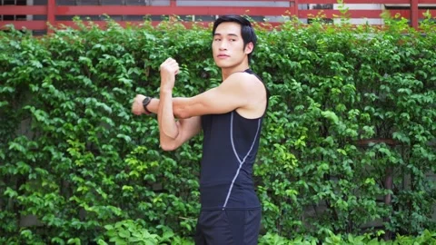 Man doing shoulder stretching in the park Stock Footage 132406791