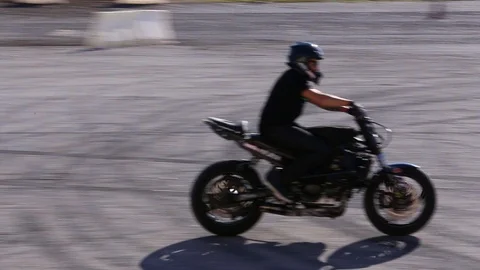 Man doing a show stunt performance on motorcycle Stock Footage 119874325