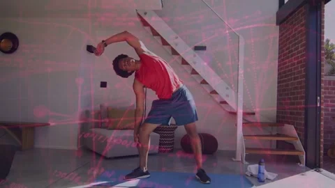 Man doing side stretch on blue mat, tapping phone and starting onscreen posture Stock Footage 333396752