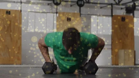 Man doing singlearm dumbbell rows  and  pushups, shifting weight starting set Stock Footage 330602653