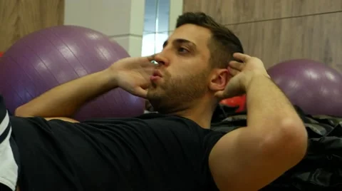 Man doing sit ups and crunches exercising abdominal muscles Stock Footage 65819326