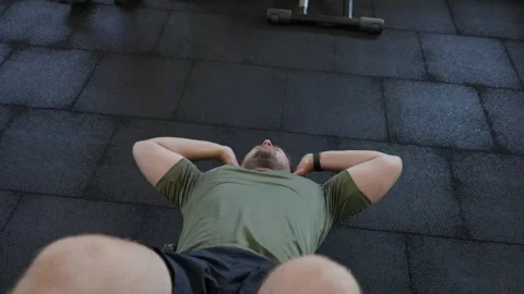 Man doing sit ups, exercising his abdominal muscles in a gym Stock Footage 339598375