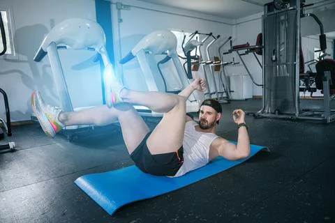 Man doing sit ups with his legs. ABS routine and training his core muscles. G Stock Photos