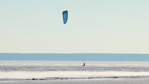 The man doing snowkiting on the icy snow field Stock Footage 196071809