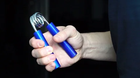 Man doing the sport exercises using hand strengthener Stock Footage 103229338