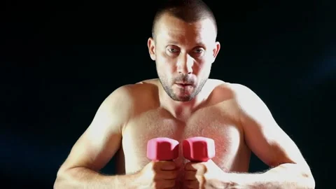 Man doing sports exercise spreading his arms with dumbbells Stock-Footage 134951683