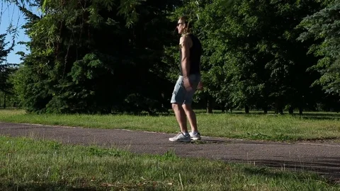 A man doing squats in the park Stockbeeldmateriaal 76819423