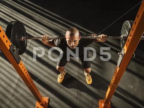 Man doing squats Stock Photos
