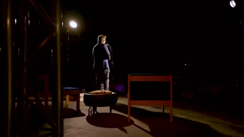 Man doing Stand Up Comedy Acting on Stage Alone in the Spotlight Stock Footage 255130876