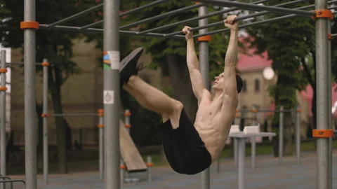 The man is doing stomach exercises in the park. Stock Footage 196226501