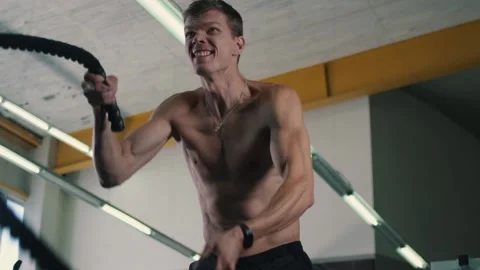 Man doing strength exercises in the gym Stock Footage 144584263