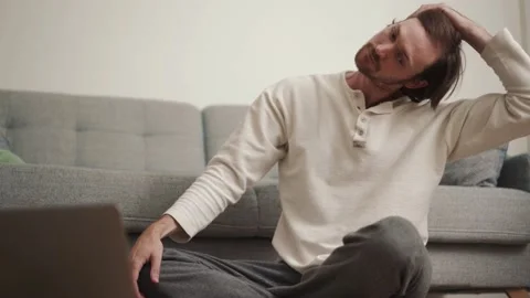 Man doing stretching according to video tutorial Stock Footage 166683907