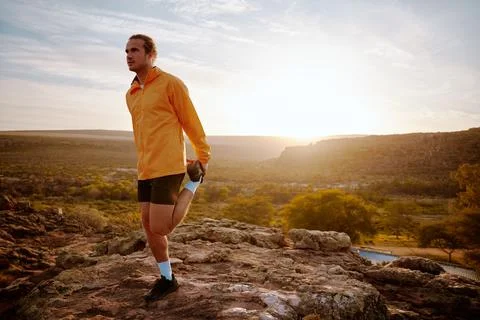 Man doing stretching and preparing for workout and running outdoors Stock Photos