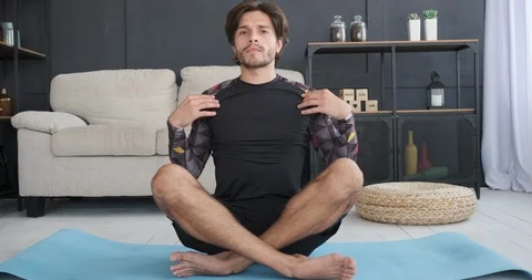 Man doing stretching exercise at home Stock Footage 117706164