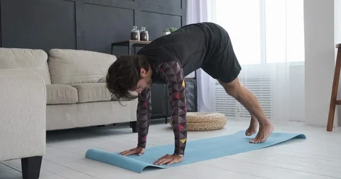 Man doing stretching exercise at home Stock Footage 117706523