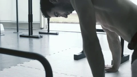 Man doing stretching exercises at the gym Stock Footage 127436639