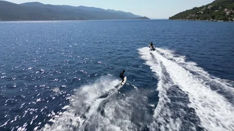 Man doing surf being pulled by a jetski on beautiful sea Video stock 216926163