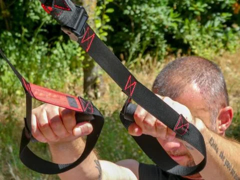 Man doing suspension training Stock Photos