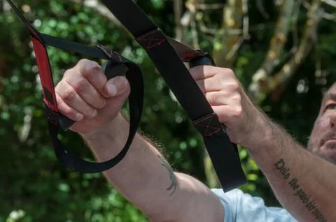 Man doing suspension training Stock Photos