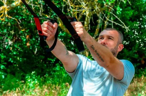 Man doing suspension training Stock Photos