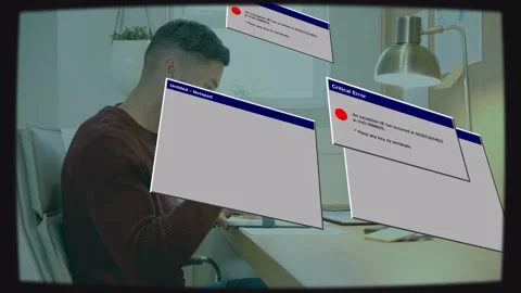 Man doing tech work at desk, retro error windows appearing then floating over Stock Footage 333034917