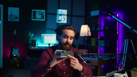 Man doing technology review of wireless portable speaker Stock Footage 306688955