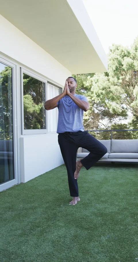 Man doing tree pose on balcony, shifting weight to start, animated balance line Stock Footage 345322457