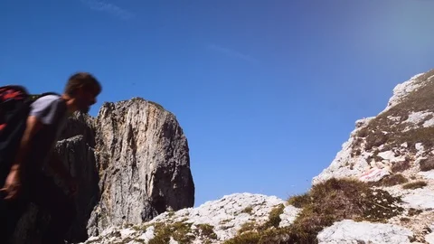Man doing trekking in the mountains, walking to the top, Alta Badia mountains Stock Footage 97564431