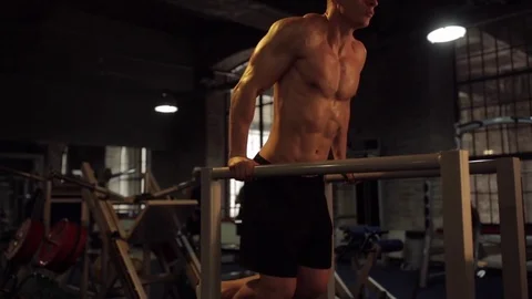 Man doing triceps dip on parallel bars in gym Stock Footage 78802298