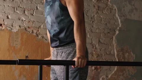 Man doing triceps dip on parallel bars in gym Video stock 135890243