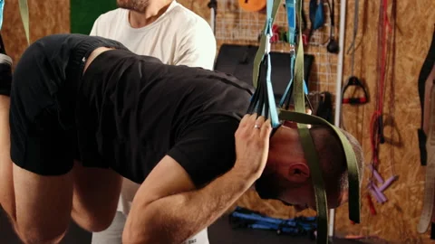 Man doing trx suspension straps. Young man doing push-ups in air while hanging Stock-Footage 195501631