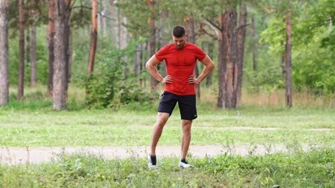 Man doing warm-up of the joints of the legs before training Video stock 146836376