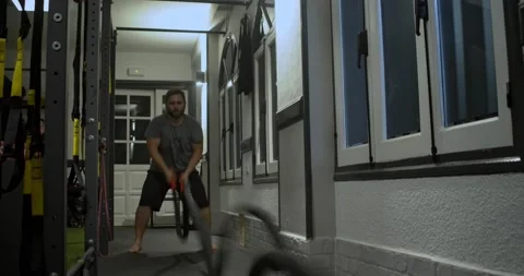 Man doing waves with undulation ropes.Real people , battle rope Stock Footage 166534269