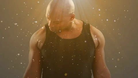 Man doing weight curls in studio, beam activating particles showing arm muscles Stock Footage 333936762