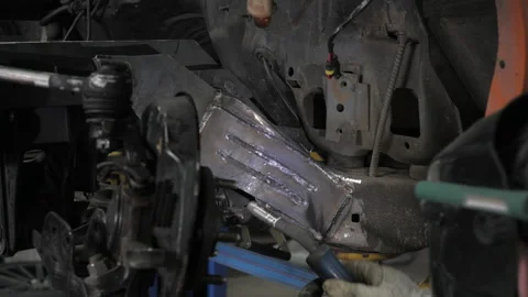 Man doing welding work. Welder welding a metal parts on vehicle Stock Footage 139289071