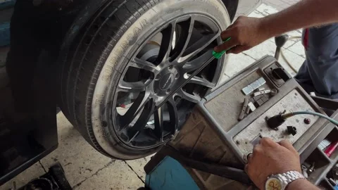 Man doing wheel balancing on the car 스톡 동영상 155497495