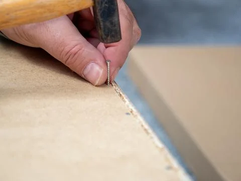 A man is doing work assembling furniture. Stock Photos