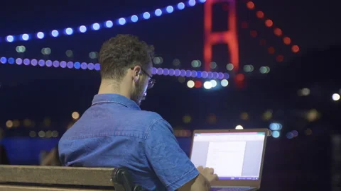 Man doing work on laptop against night sea view. Stock-Footage 212854768