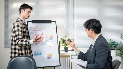 A man doing work presentation on white board and businessman boss asking qu.. Stock Photos