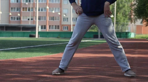 Man doing workout in an outdoor stadium. Morning gymnastics Stock Footage 68938165