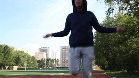 Man doing workout in an outdoor stadium. Morning gymnastics Stock Footage 68938778