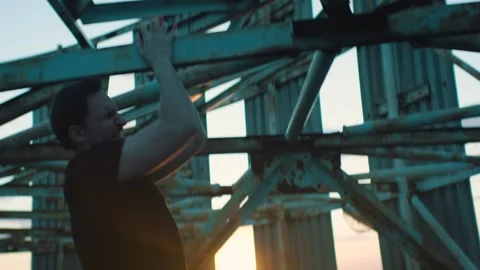 Man doing workout on the roof of a skyscraper at sunset Stock-Footage 131400619
