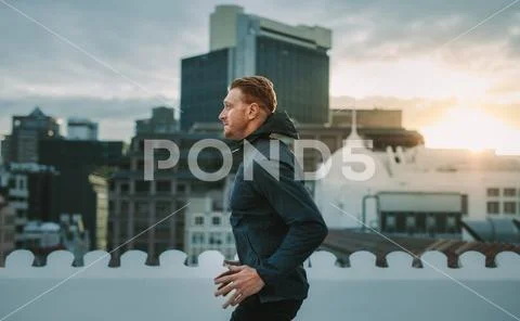Man doing workout on rooftop Stock Photos