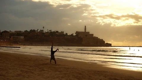 Man doing yoga on an beach Stock Footage 82702075